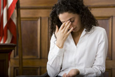 woman testifying, hand on face